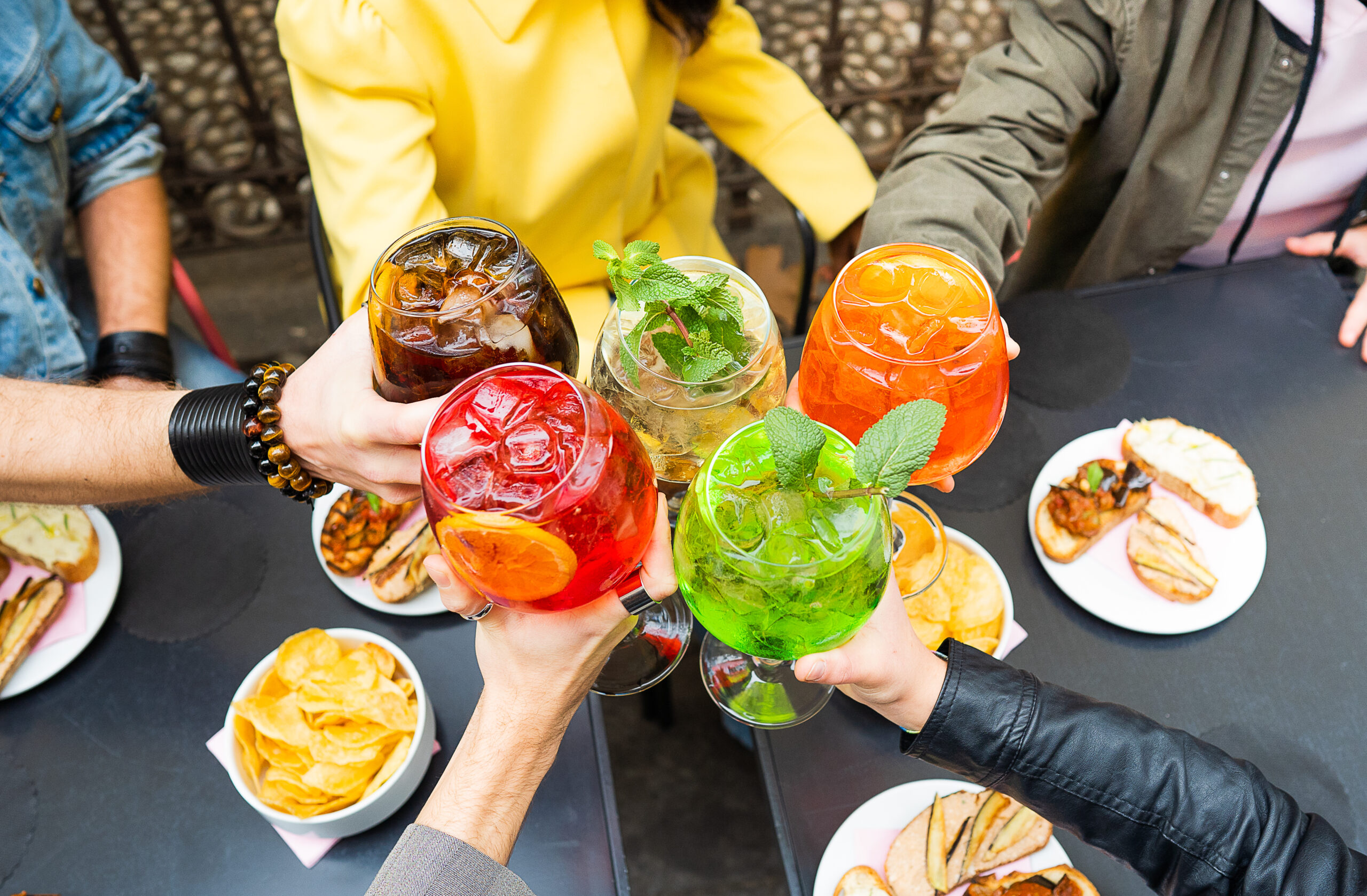 Friends toasting with cocktails drinks while having fun together - NinjaFitness